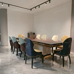 High-Gloss Amber Burl Wood Dining Table with Cream Quilted Leather Base and Metal Inlay